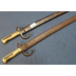 Two 19th C French Chassepot bayonets, with steel scabbards and ribbed brass grips