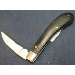 2 inch shaped single bladed pocket knife with curved two piece grips