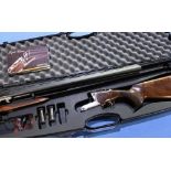 Cased Akkar Triple Crown 20 bore triple barrel shotgun with 26 inch multi-choke barrels, single