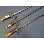 A group of three French Gras type bayonets with broad back straps, with traces of engraved detail