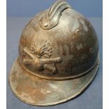 WWI French artillery steel helmet with traces of painted detail complete with leather liner.