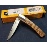 Boxed as new Buck Knives pocket knife with 2 1/2 inch blade and two piece polished wood grips