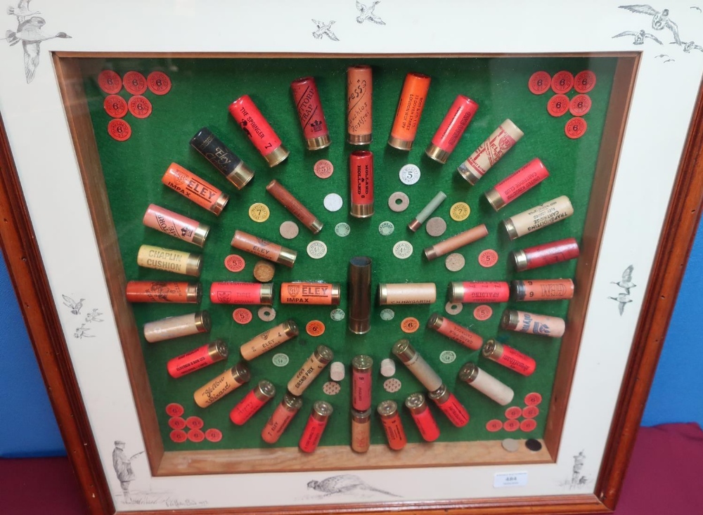 Framed & mounted shotgun cartridge display containing various vintage paper and brass cased