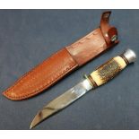 German made sheath knife with 4 1/2 inch blade and horn grip, complete with tooled leather sheath