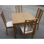 Modern beech extending dining table and four chairs with upholstered seats