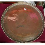 Extremely large Eastern copper charger with engraved detail and raised pie crust edge, with traces