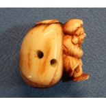 19th C carved ivory Netsuke in the form of a Dutchman carrying a sack (height 4cm)