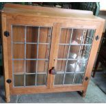 Robert Thompson 'Mouseman' oak side cabinet enclosed by two lead glazed cupboard doors, with further