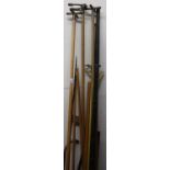 Selection of various assorted billiard cues, vintage golf clubs, African type carved wood barbed