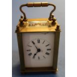 Small brass French eight day carriage clock with key (with beveled glass panels) (front panel