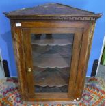 19th C oak corner wall mounted cabinet enclosed by a single glazed door