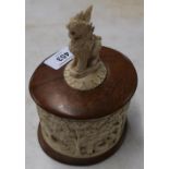 19th/20th C eastern carved ivory jar with wooden base and top crested with the figure of an