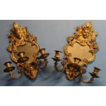 Pair of gilt metal three branch candelabra wall mirrors, crested with cherub faces (approx height