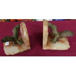 Pair of rough cut onyx style bookends with cast metal figures of eagles with outstretched wings, a