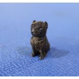Miniature cold painted bronze figure of a seated pug dog (2.5cm high)