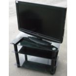 Hitachi 31 inch flat screen TV complete with three tier smoked glass stand