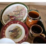 Two boxes containing a large selection of various decorative ceramics, including various sporting