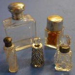 Group of five glass dressing table and scent bottles with silver hallmarked tops, collars and one