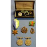 WWII Atlantic Star and two Defence medals, RAF cap badge, Medical Corp badge and a cased silver gilt