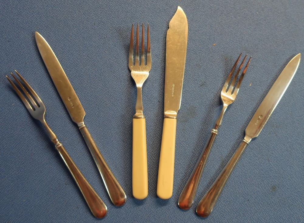 Six pairs of plated fish knives and forks and twelve pairs of dessert knife and forks