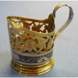 Russian style white metal, niello and gilt metal glass holder with loop handle (8.5cm high), to