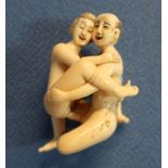 Early 20th C carved ivory erotic Netsuke with signature panel to the buttock (height 4.5cm)