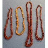 Four various amber and amber style necklaces