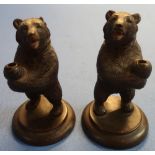 A pair of carved Black Forest style bears on circular bases (15cm high)