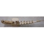 Early 20th C Persian carved ivory tusk in the form of a boat with various figures mounted on