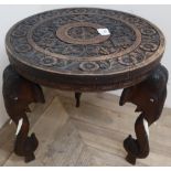 Small carved Indian hardwood table with three elephant head supports (diameter 38cm, 38cm high)