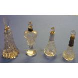 Group of four cut glass scent bottles, one with silver hallmarked collar and three with unmarked