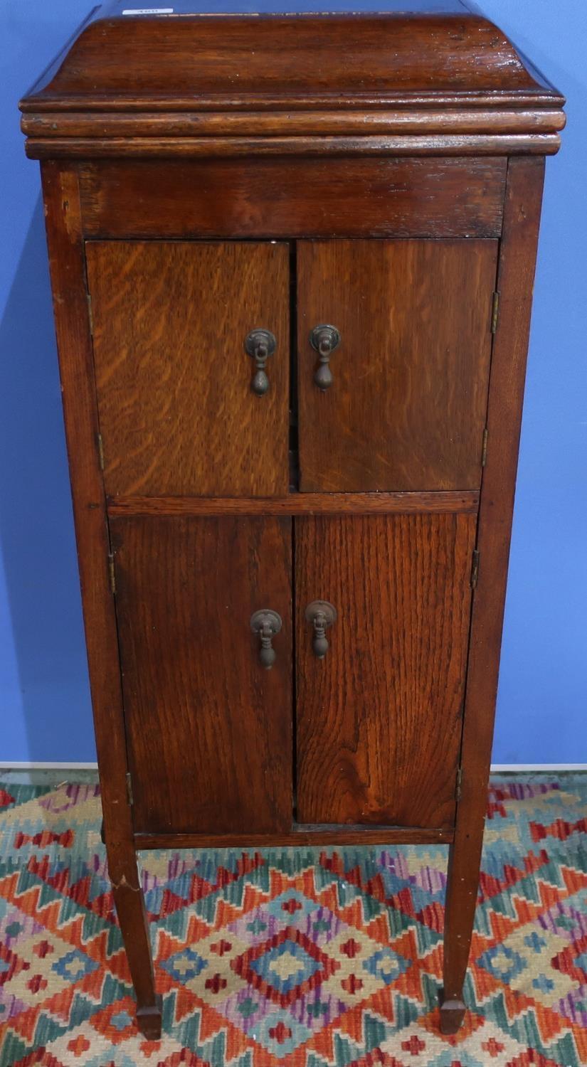 Early 20th C oak cased gramophone with hinged top and four cupboard doors, with various records