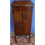 Early 20th C oak cased gramophone with hinged top and four cupboard doors, with various records