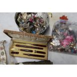 Box containing various costume jewellery, ceramic brooch, material, buttons, cased writing set etc