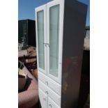 Modern white laminate bathroom style cabinet with two cupboard doors above two drawers and two