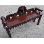 Carved oak hall bench/window seat with elaborate carved detail and turned arm supports (121cm x 30cm