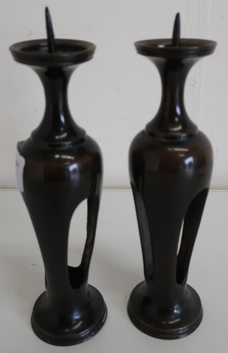 Pair of Japanese bronze candlesticks on circular bases (height 20cm)