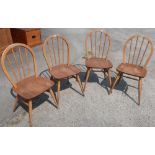 Set of four light elm Ercol stick back dining chairs with H shaped understretcher