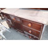 Victorian stained pine sideboard with central drawer above panelled cupboard door flanked by six