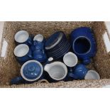 Rectangular wicker basket containing a part Denby blue tea service with eight cups, milk jug,