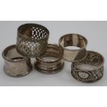 Four various silver hallmarked napkin rings and one silver plated napkin ring