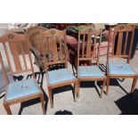 Four Edwardian oak dining chairs with drop in seats