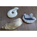 Three carved Inuit style marine ivory figures, one with engraved detail of a bird, another of a