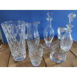 Three glass decanters, large etched glass water jug and two cut glass vases