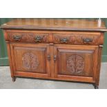 Late Victorian mahogany sideboard with two drawers above two cupboard doors with carved and panelled