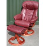 Revolving reclining leather armchair with associated footstool