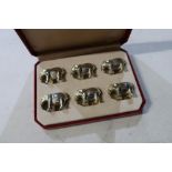 Cased set of six Eastern style white metal elephant name place/menu holders