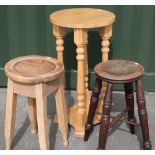 Two country style four legged stools and a light oak jardiniere stand on four turned wood