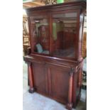 19th C mahogany cabinet with two upper glazed doors with three internal shelves above two frieze