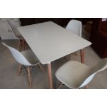 Ikea rectangular table on light wood supports and a set of four chairs